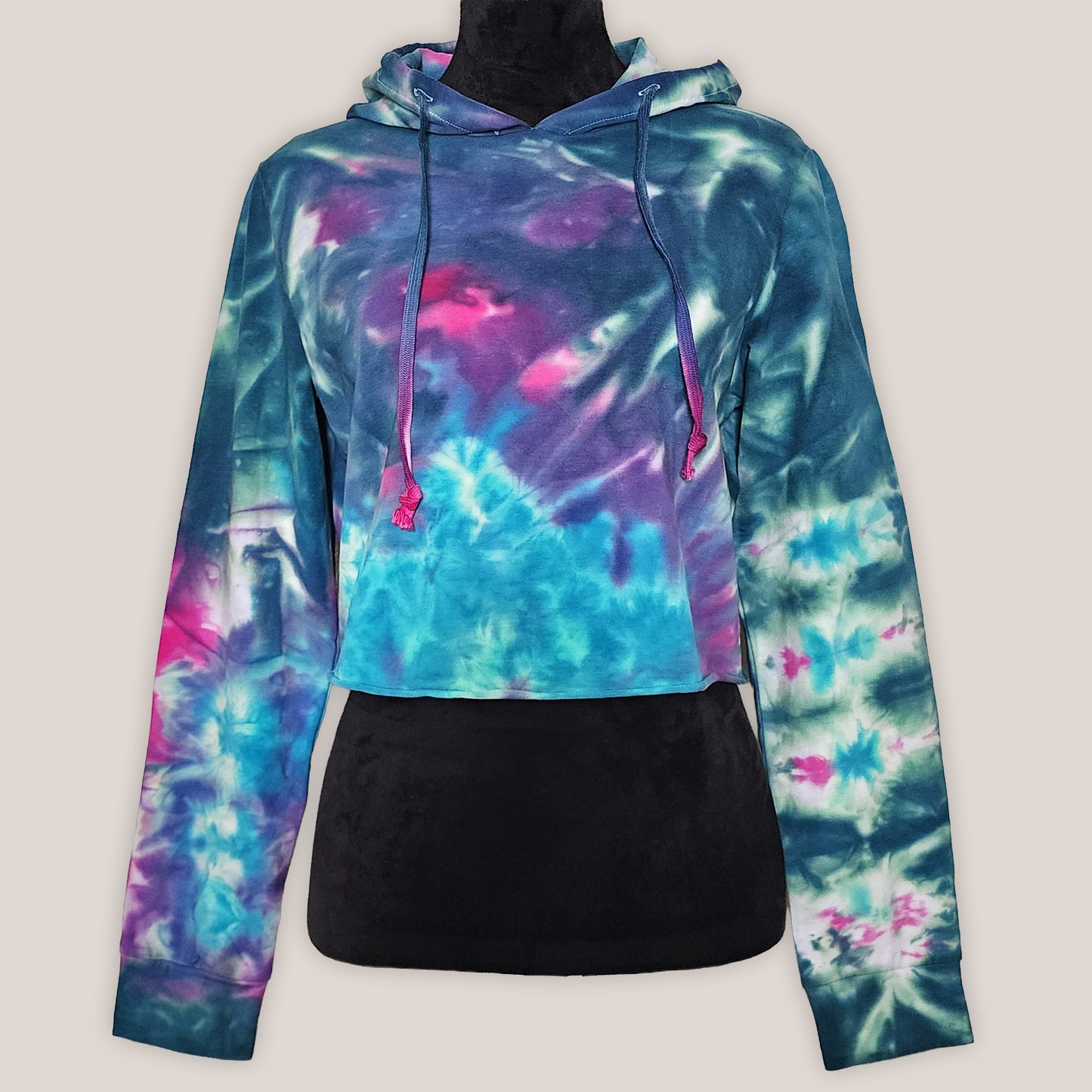 Tie-dye hoodie on a black mannequin on a beige background