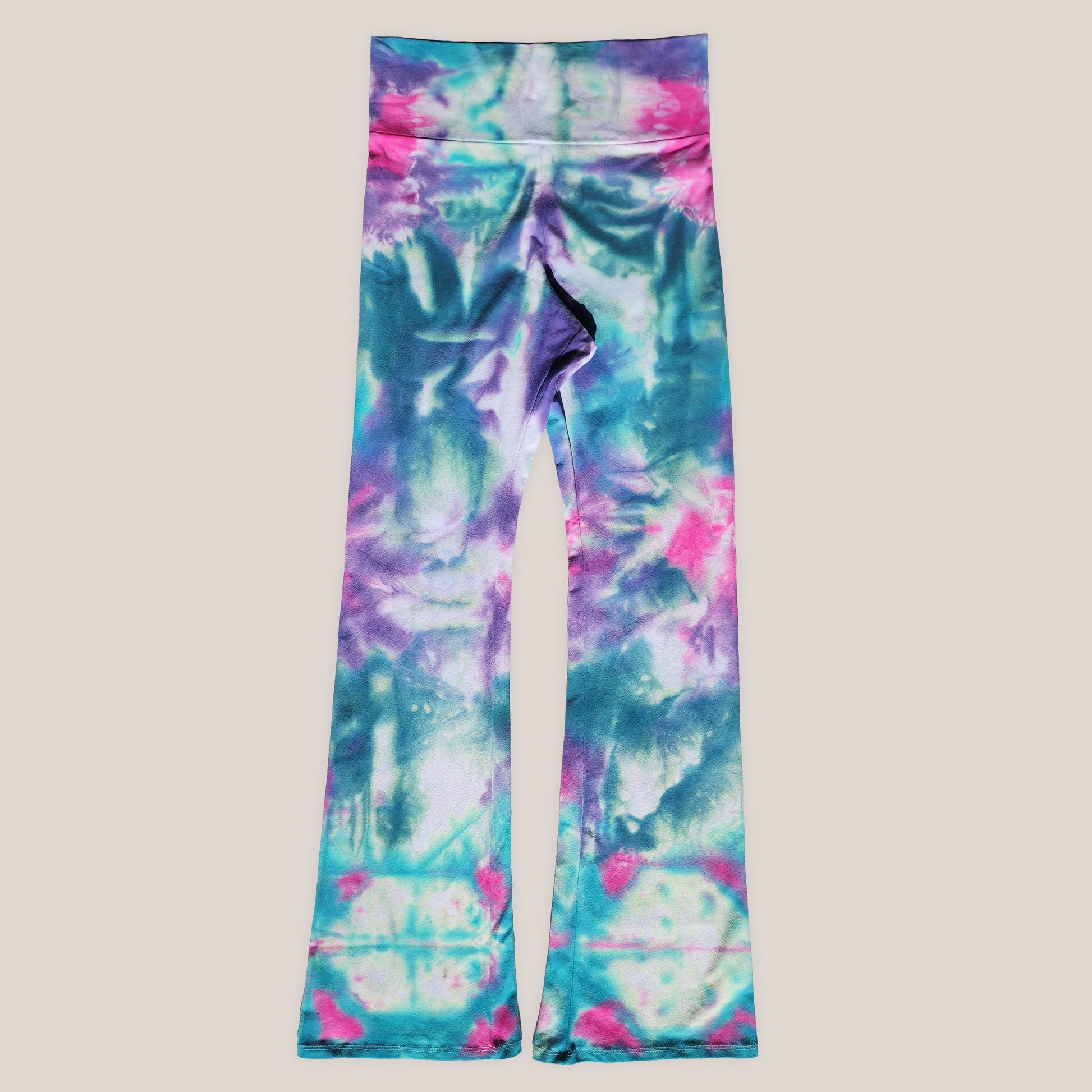 Tie-dye leggings with pink, blue, and green pattern on a light gray background
