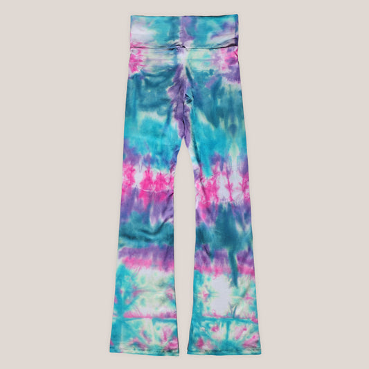 Tie-dye leggings with blue, pink, and green pattern on a beige background