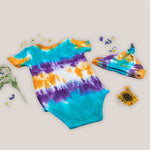 Teal, purple, and orange tie dye organic cotton bodysuit and baby hat set by Akasha Sun.