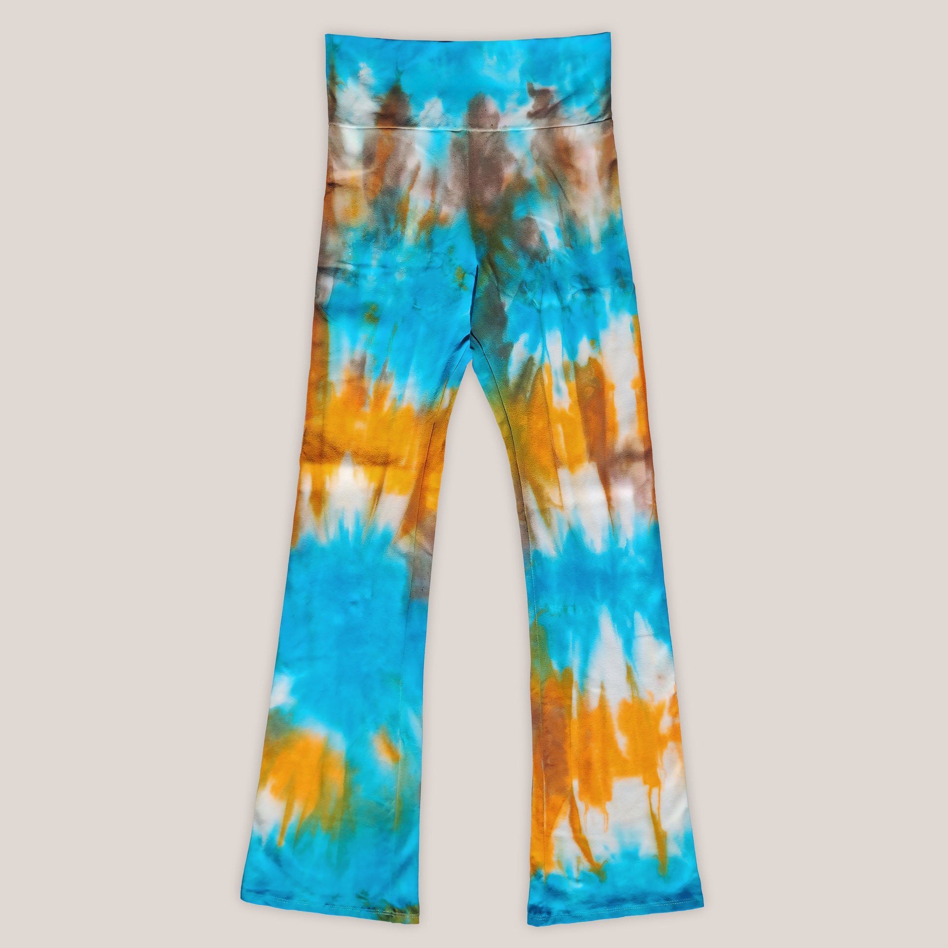 Tie-dye pants with blue, orange, and white pattern on a beige background