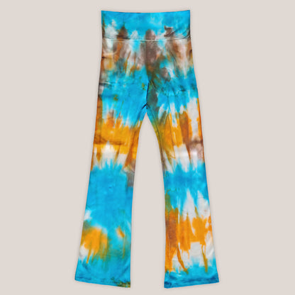 Tie-dye pants with blue, orange, and white pattern on a beige background