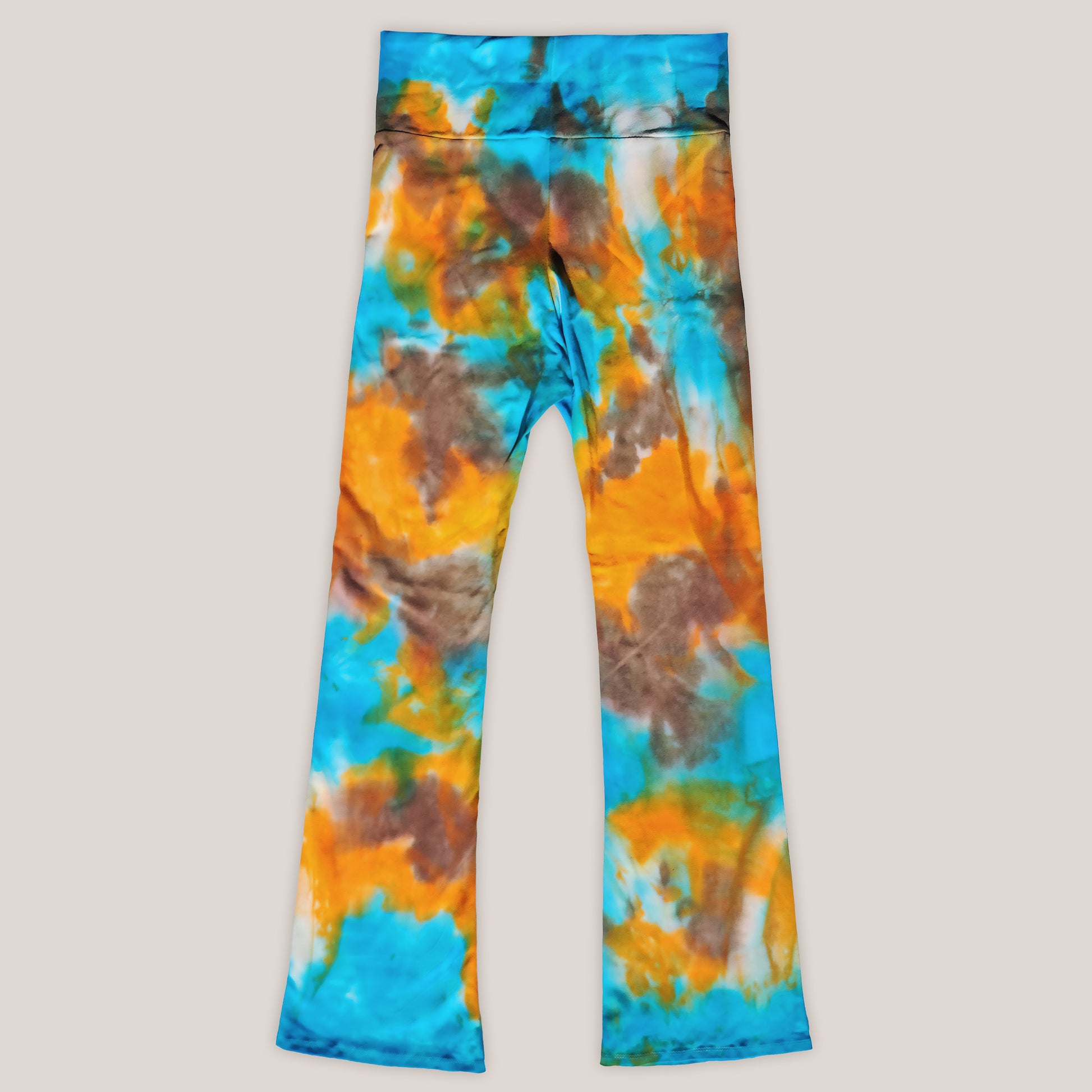 Tie-dye pants with blue, orange, and brown pattern on a light gray background