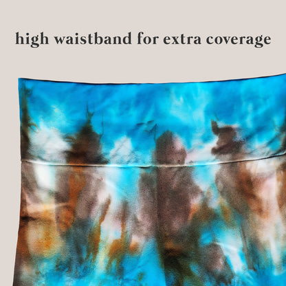 Tie dye yoga pants waistband on beige background.