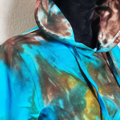 Close-up of a colorful tie-dye top with a hood.