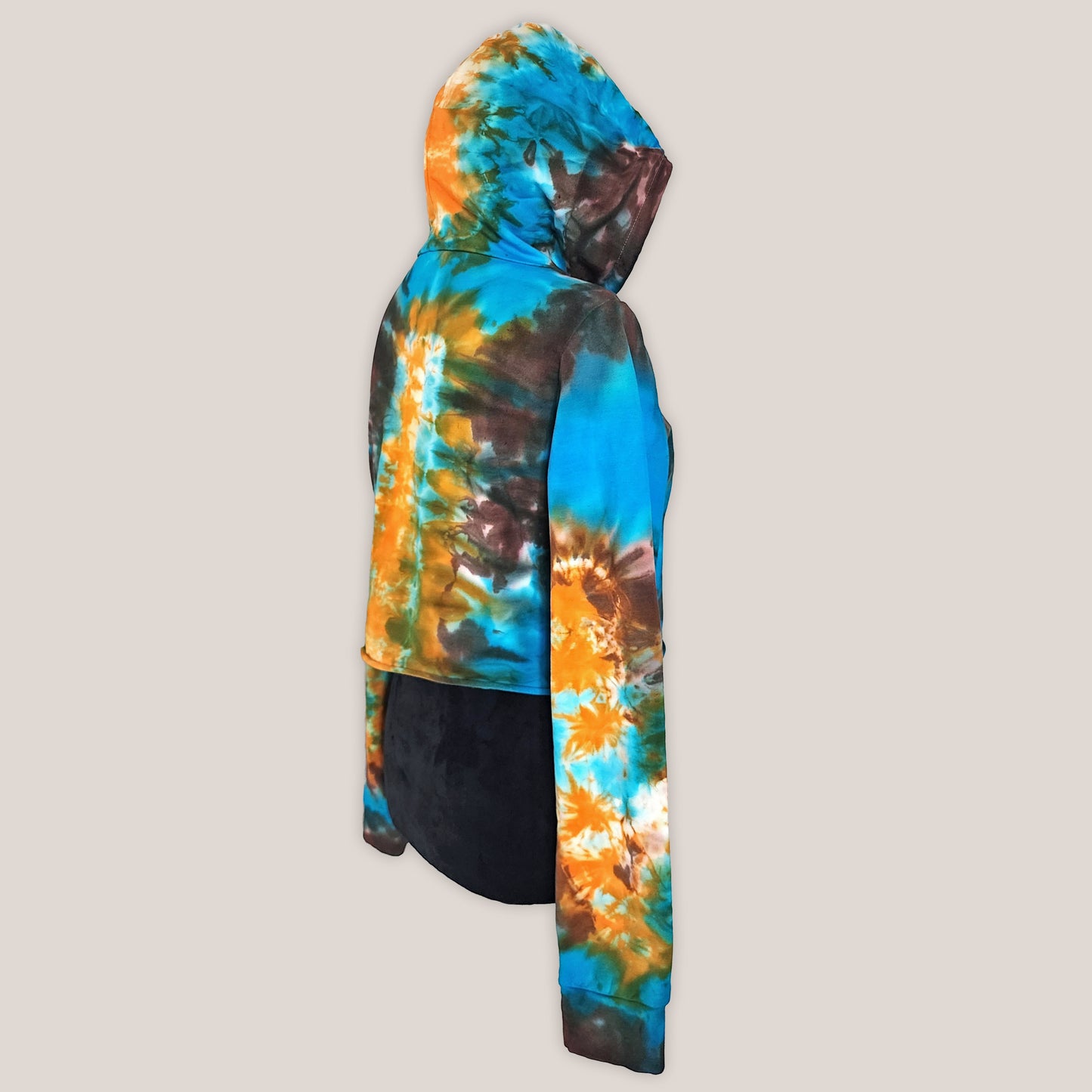 Tie-dye hoodie with blue, orange, and brown pattern on a beige background