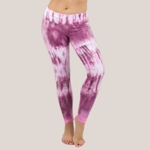 Woman wearing a pair of pink tie dye fold over leggings by Akasha Sun.