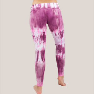 Woman wearing a pair of pink tie dye fold over leggings by Akasha Sun.