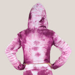 Woman wearing a pink tie dye crop top hoodie by Akasha Sun.