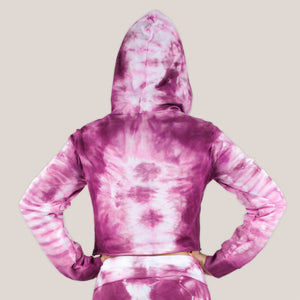 Woman wearing a pink tie dye crop top hoodie by Akasha Sun.