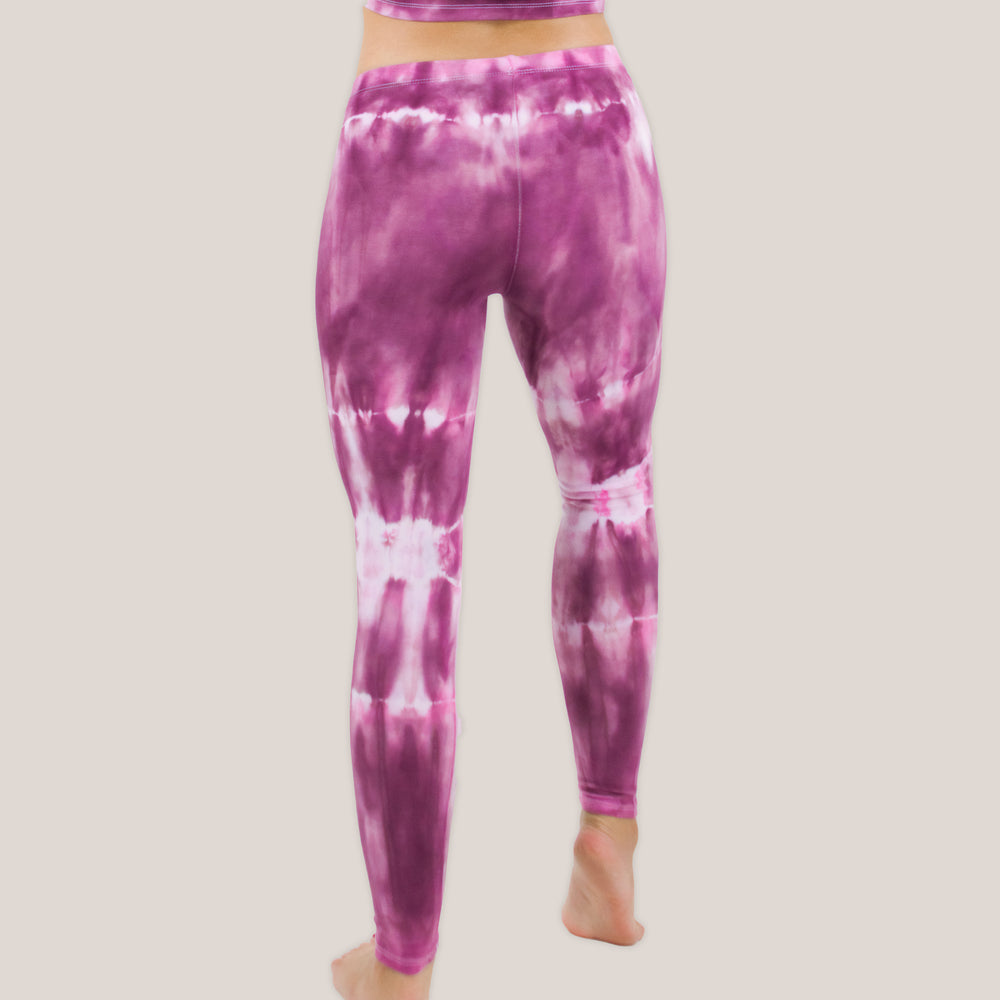 Woman wearing a pair of pink tie dye leggings by Akasha Sun.