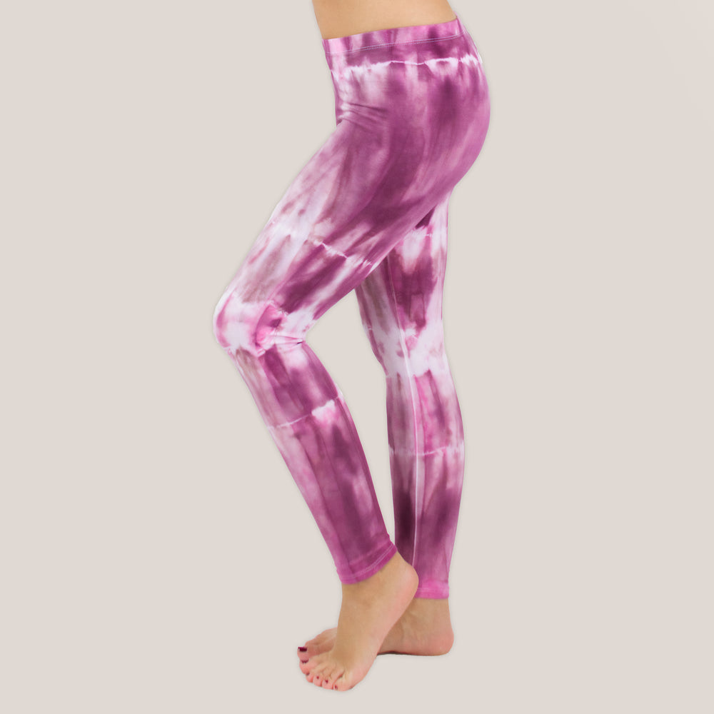 Woman wearing a pair of pink tie dye leggings by Akasha Sun.