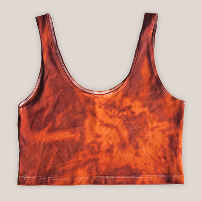 Orange tie-dye tank top on a plain background