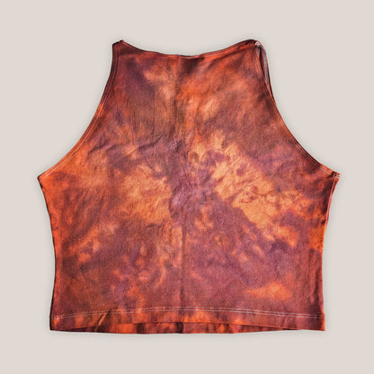 Red and orange tie dye crop top on a plain background
