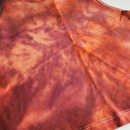 Close-up of a tie-dye pattern with shades of orange and red