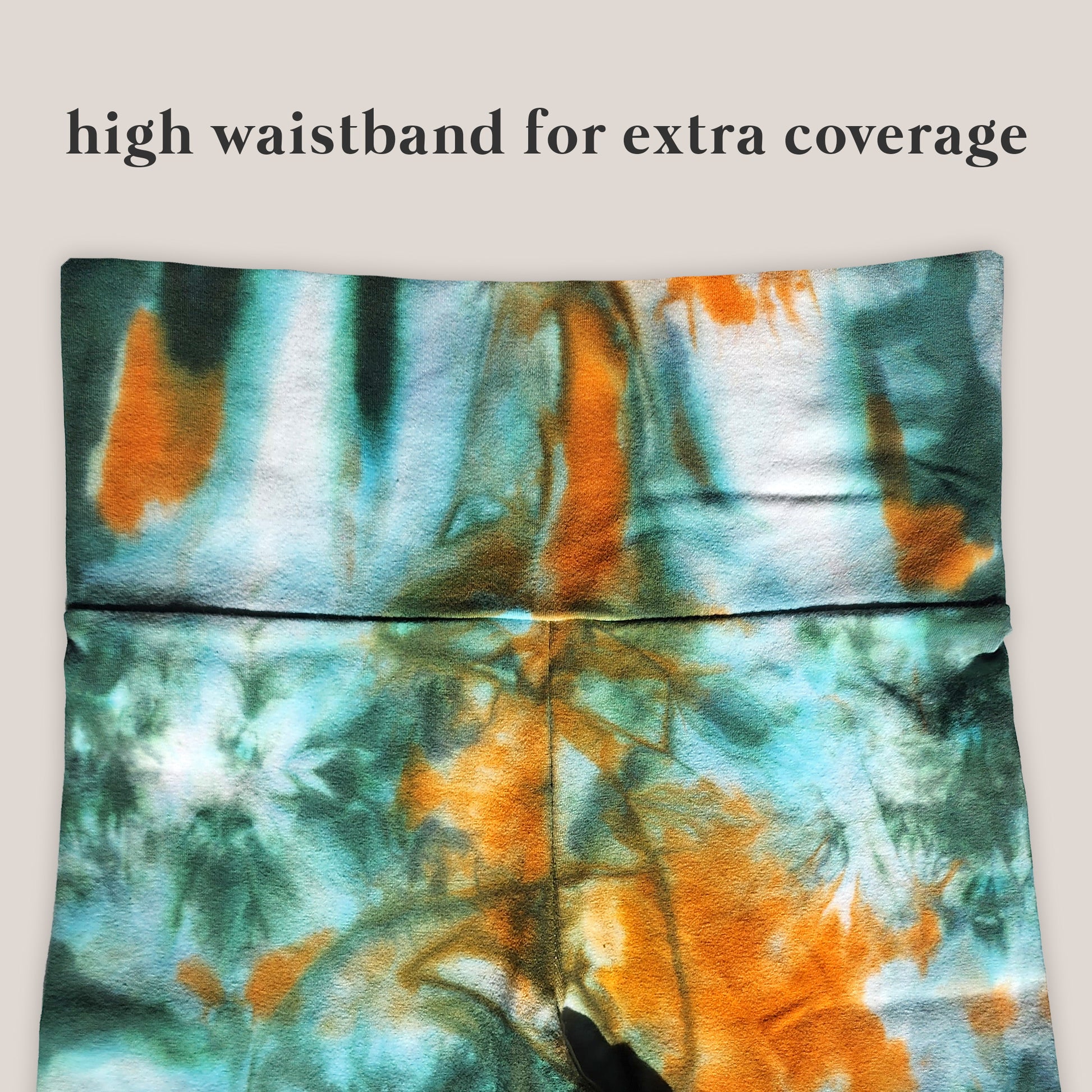 Tie-dye patterned pants with a high waistband on a light gray background