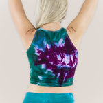 Woman wearing a teal and purple tie dye crop top by Akasha Sun.