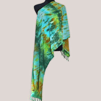 Colorful tie-dye scarf with fringes on a beige background