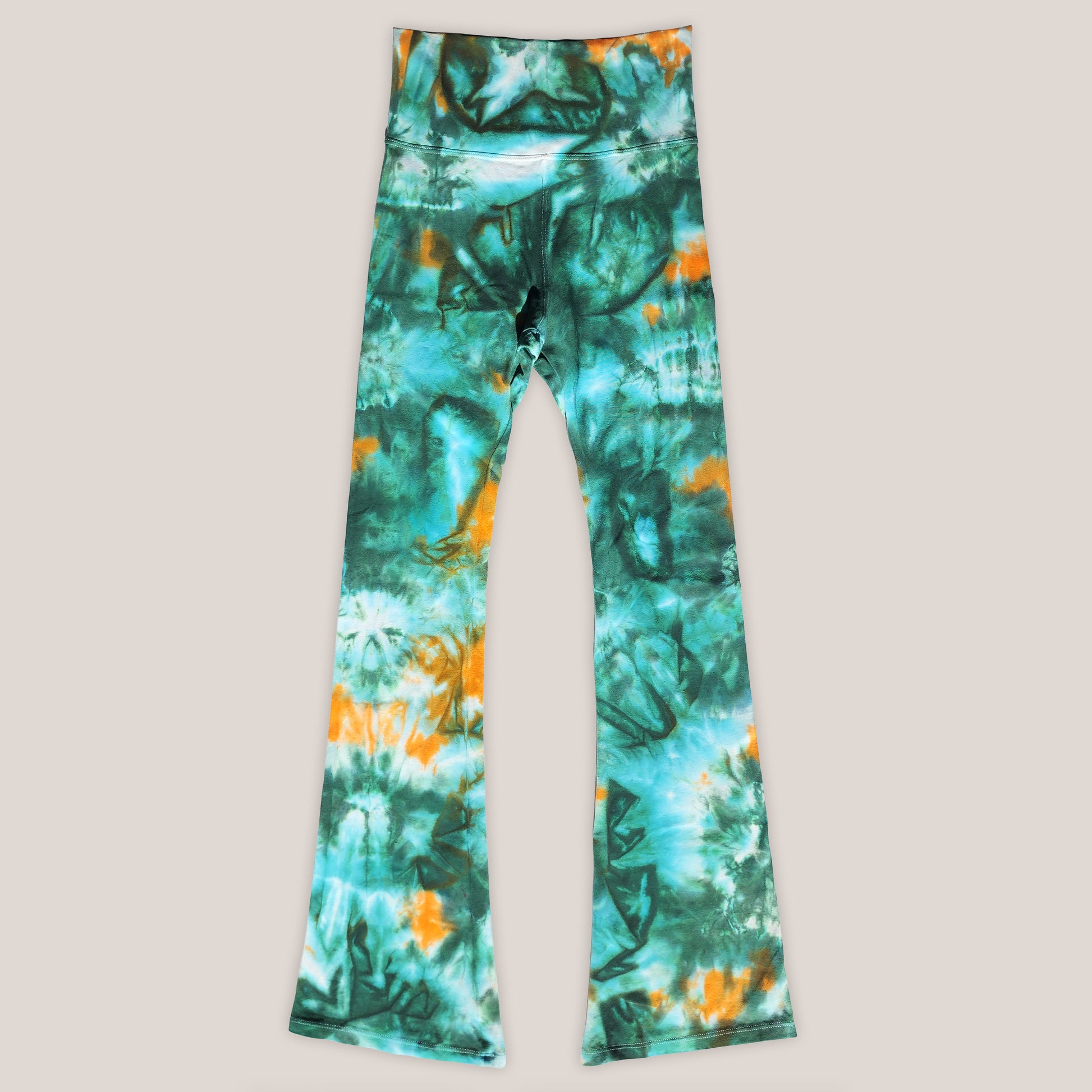 Green and orange tie-dye leggings on a light gray background
