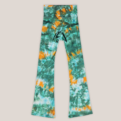 Tie-dye leggings with green and orange pattern on a light gray background