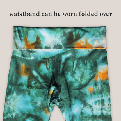 Tie-dye pants with a waistband that can be folded over on a beige background.
