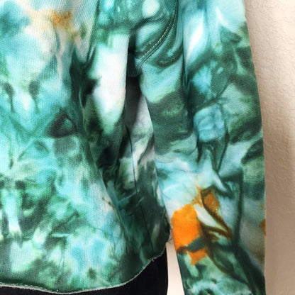 Close-up of a fabric with a green and orange pattern