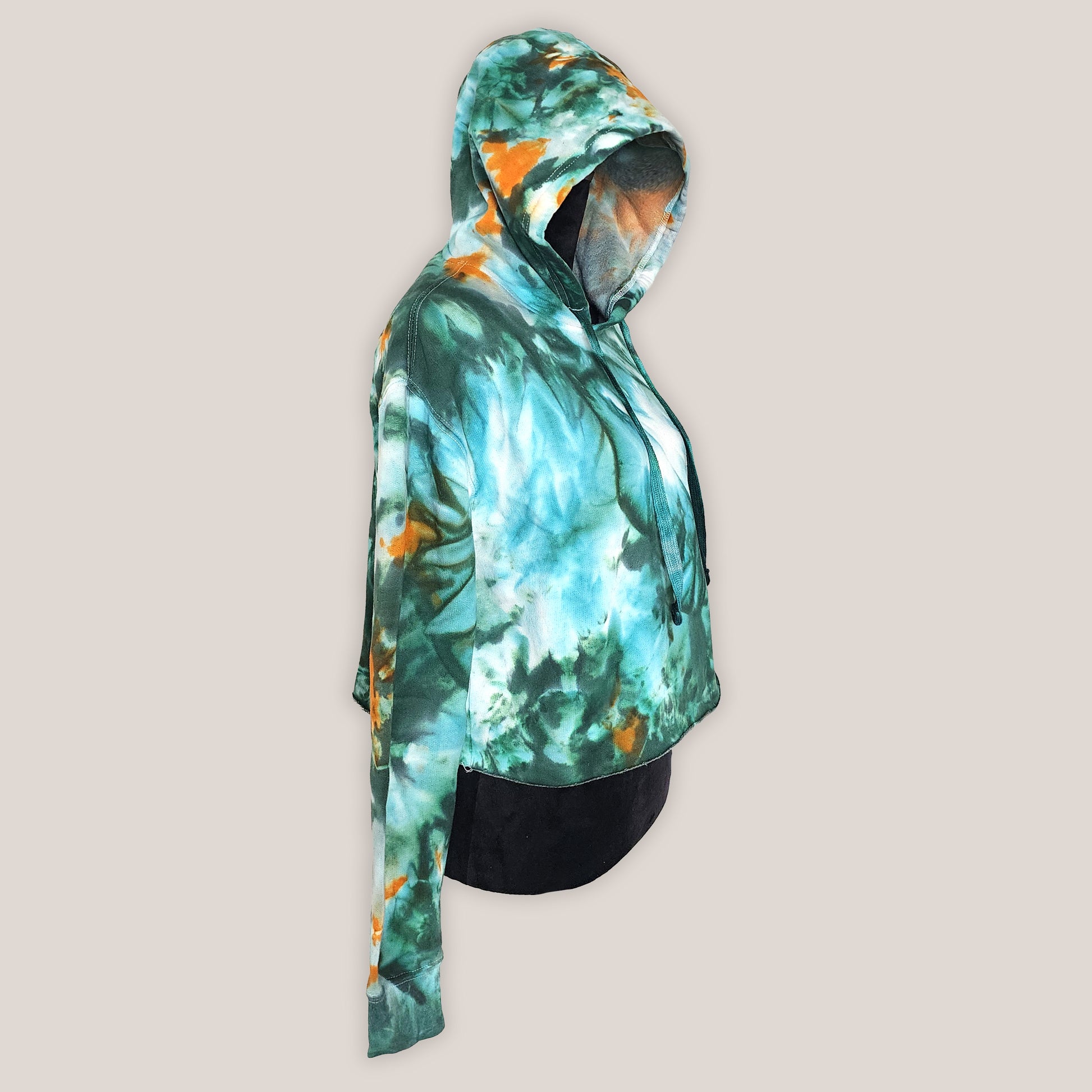 Hoodie with a tie-dye design in green and orange on a beige background