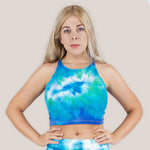 Woman wearing an aqua and teal tie dye crop top.