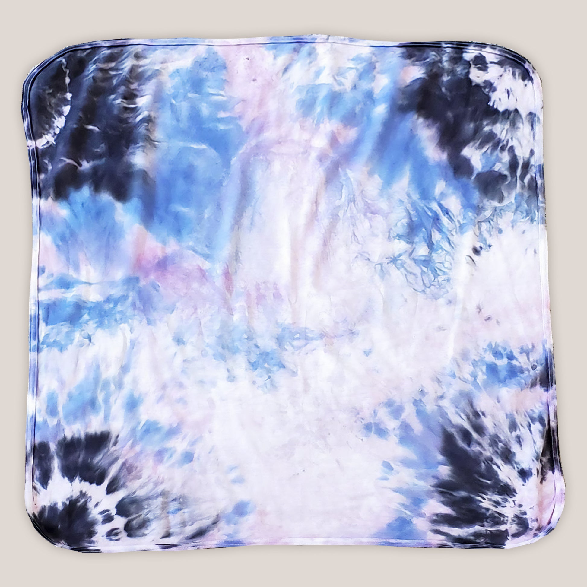 A periwinkle and black tie dye organic baby blanket with rounded corners.