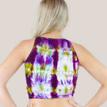 Woman wearing a purple and green tie dye crop top by Akasha Sun.