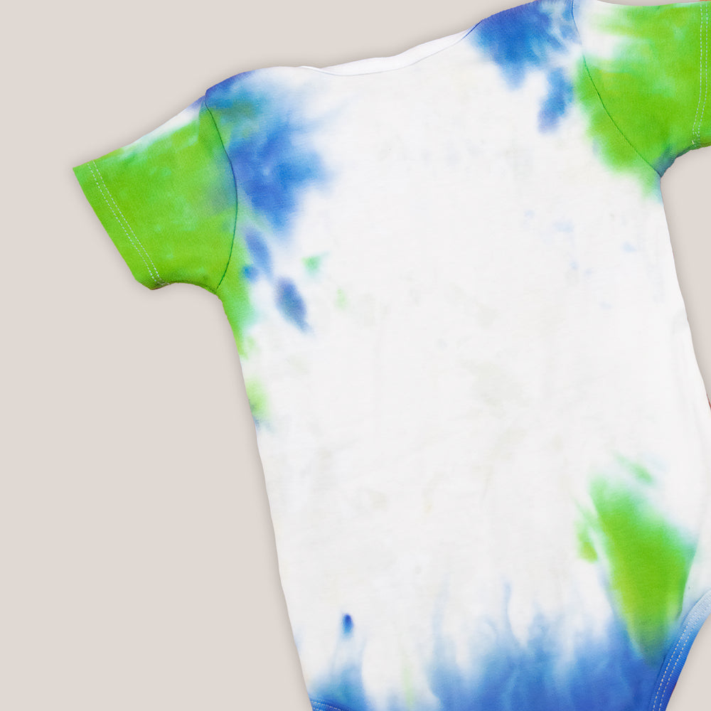 Blue, green, and white tie dye baby set that includes a bodysuit, hat, and bib.