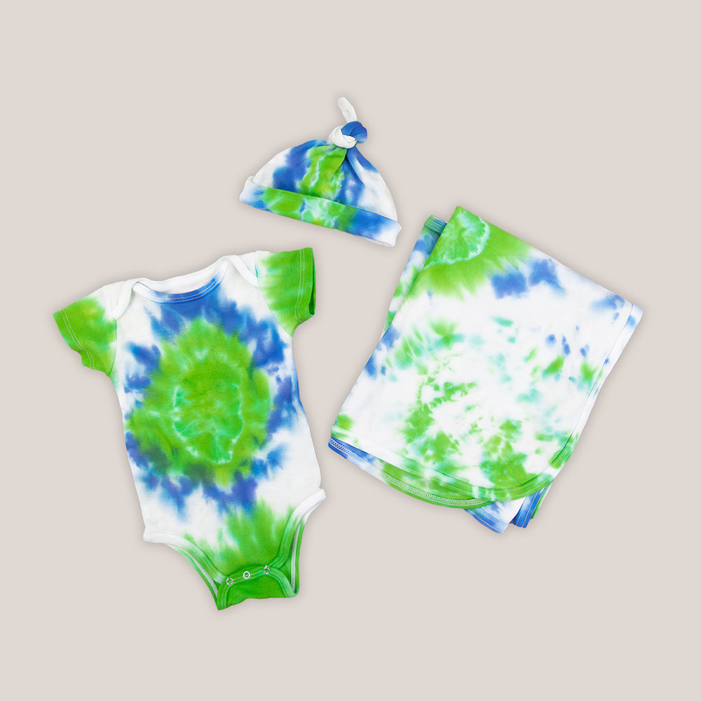 Blue, green, and white tie dye organic baby set that includes a baby blanket, bodysuit, and baby hat.