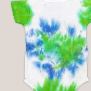 Blue, green, and white tie dye organic baby set that includes a baby blanket, bodysuit, and baby hat.