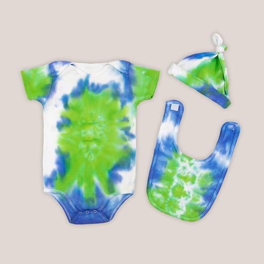 Blue, green, and white tie dye baby set that includes a bodysuit, hat, and bib.