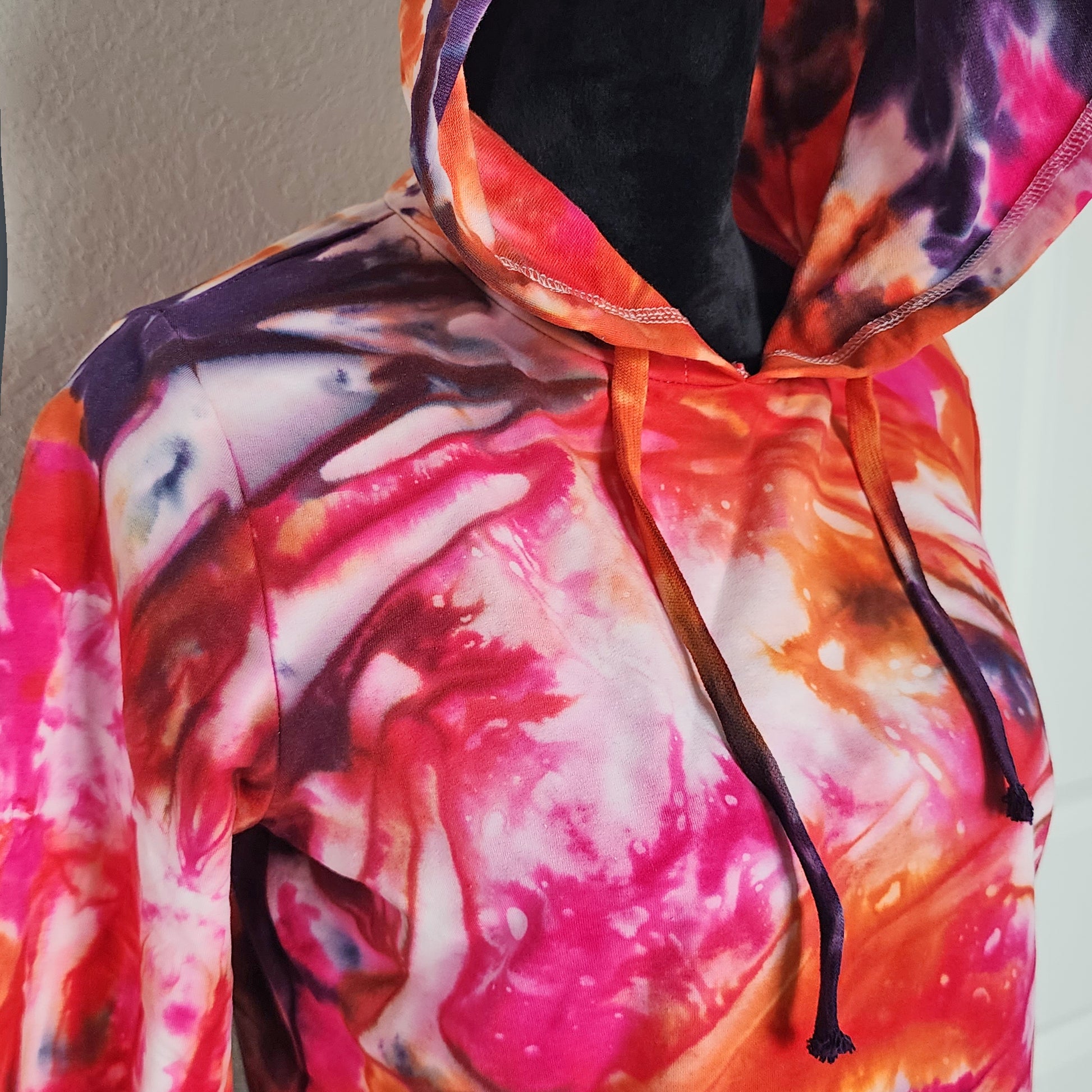Colorful tie-dye hoodie with a plain background