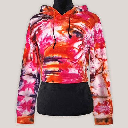 Colorful tie-dye hoodie on a black mannequin on a light beige background