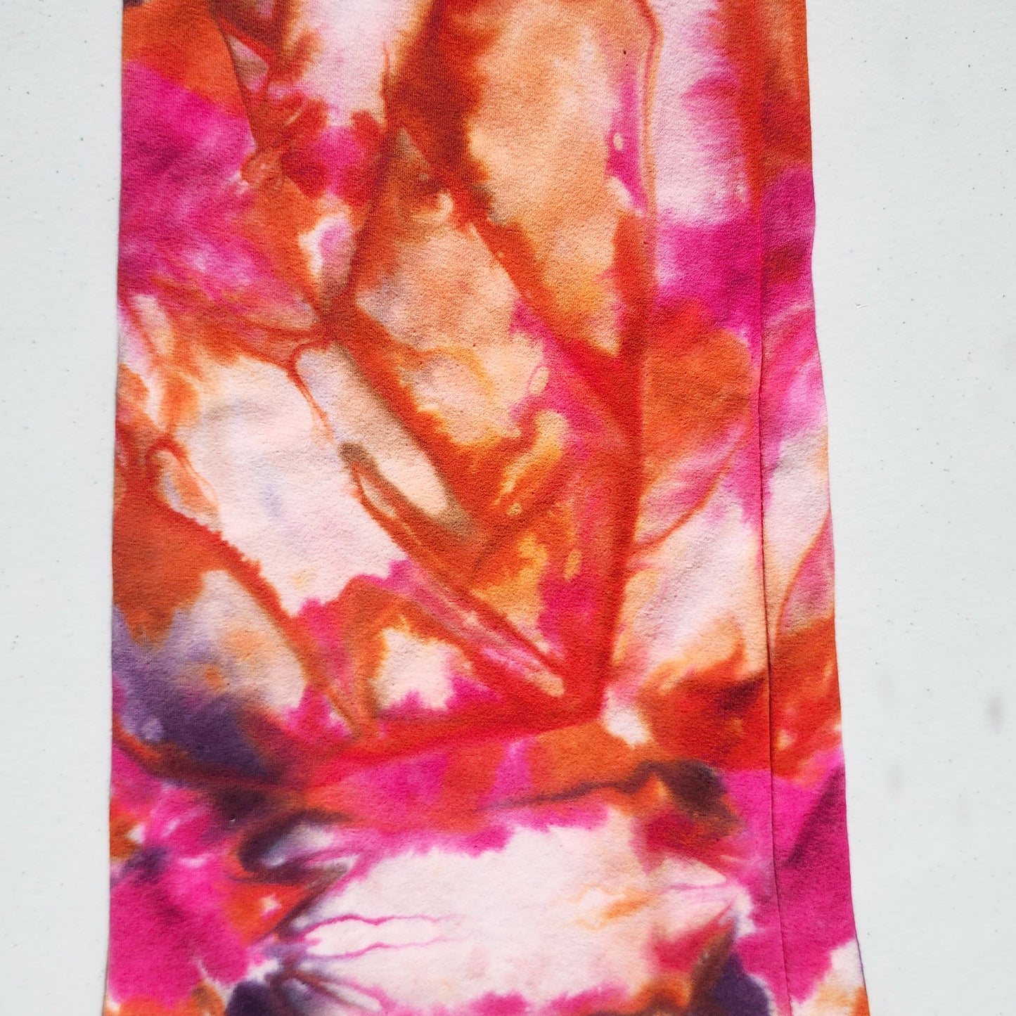 Up close colorful tie-dye pattern on pants on a white background