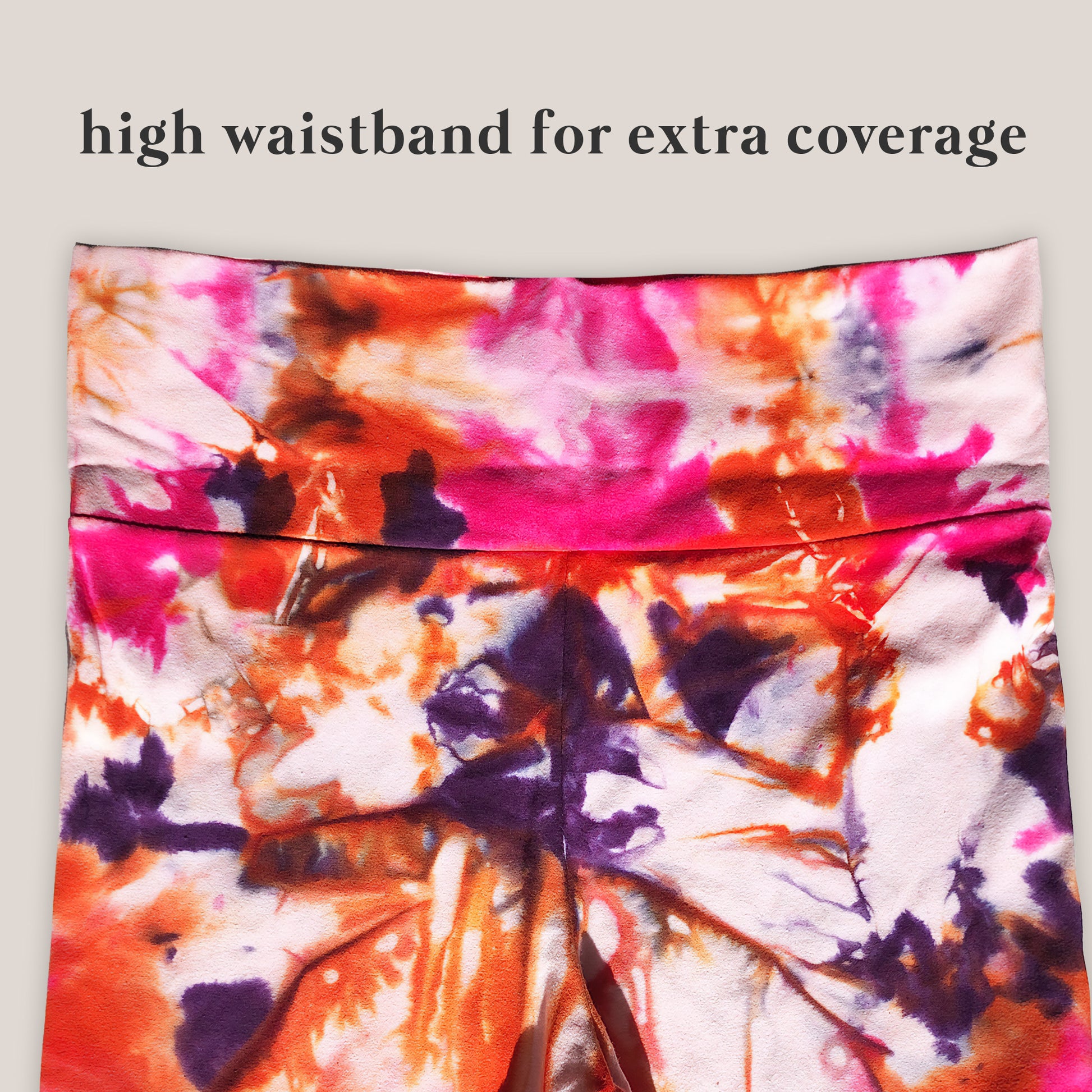 Colorful tie-dye fabric with a high waistband for extra coverage on a light gray background.