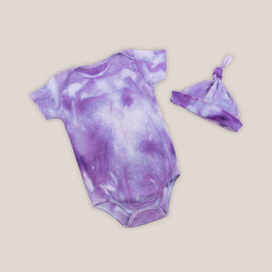 Purple organic cotton tie dye baby bodysuit and hat by Akasha Sun.