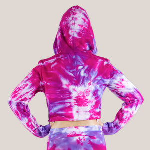 Woman wearing a pink and purple tie dye hoodie crop top by Akasha Sun