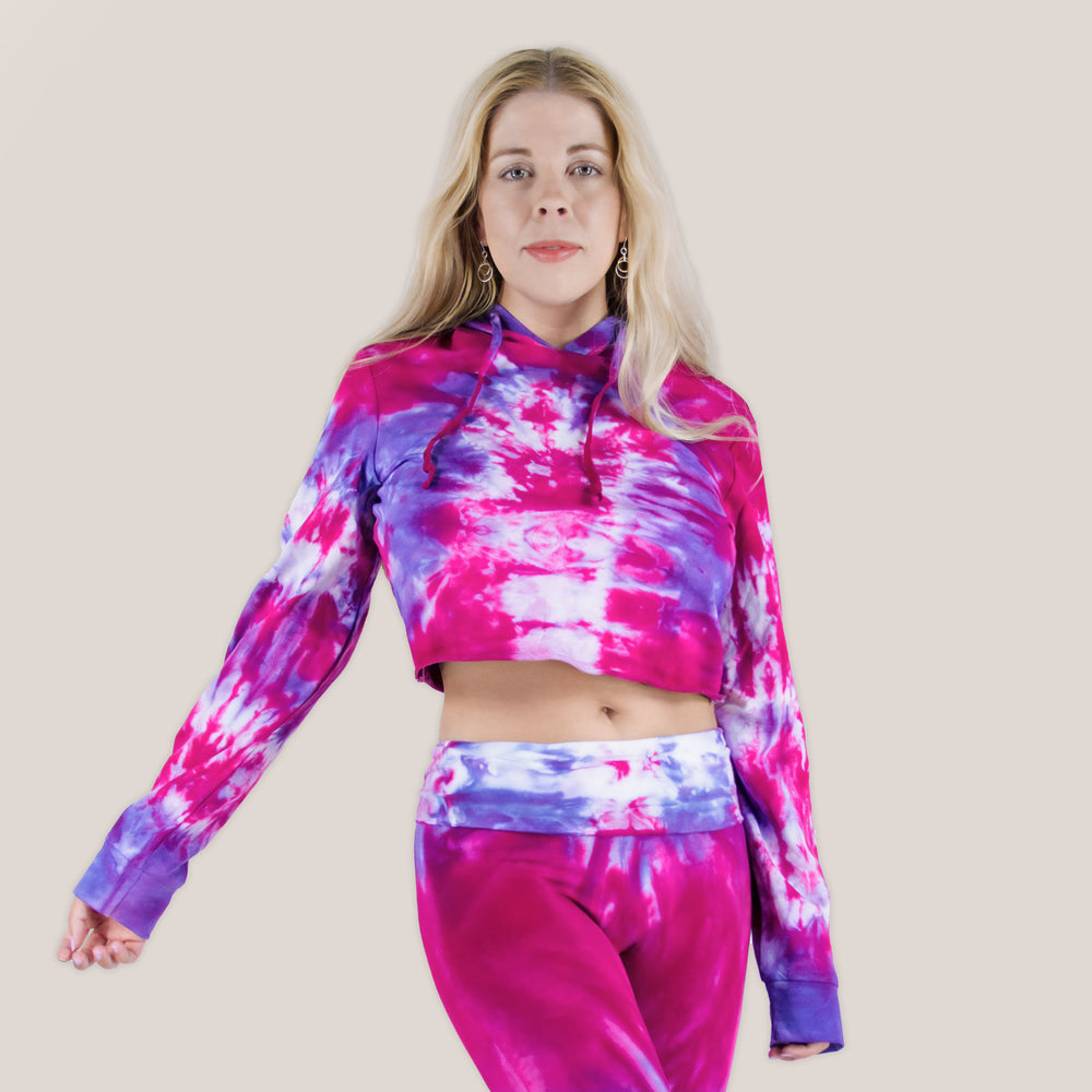 Woman wearing a pink and purple tie dye hoodie crop top by Akasha Sun