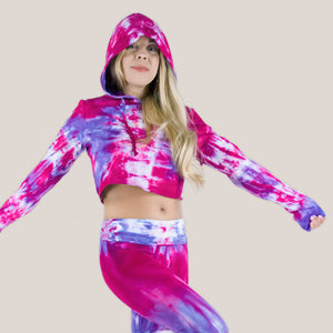 Woman wearing a pink and purple tie dye hoodie crop top by Akasha Sun