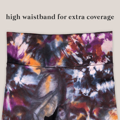 Tie-dye patterned yoga pants with a high waistband on a beige background