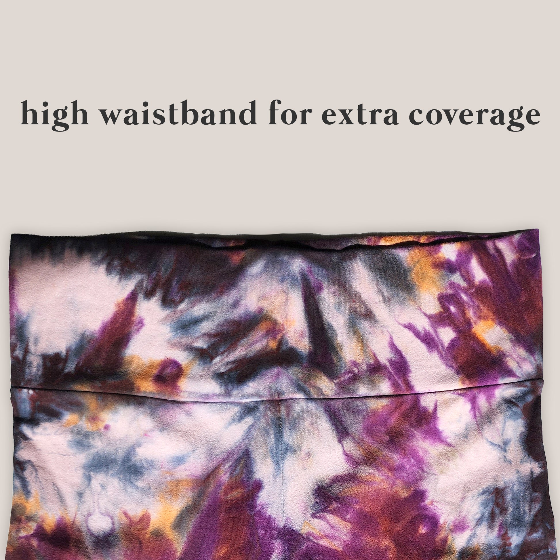 Tie-dye patterned pants with text 'high waistband for extra coverage' on a plain background
