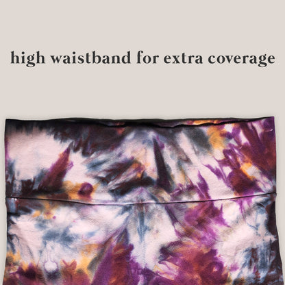 Tie-dye patterned pants with text 'high waistband for extra coverage' on a plain background