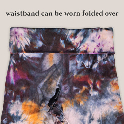 Tie-dye waistband with text indicating it can be worn folded over on a light gray background