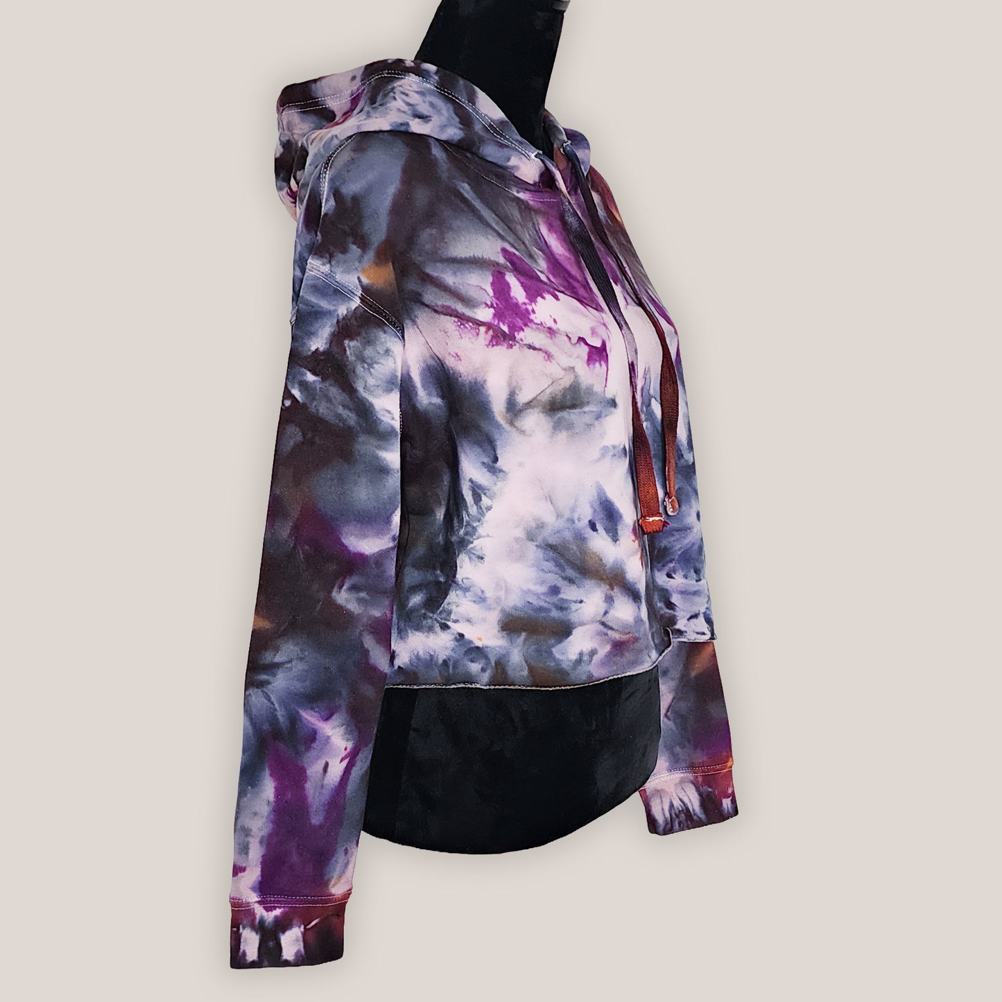 Colorful tie-dye hoodie on a light gray background