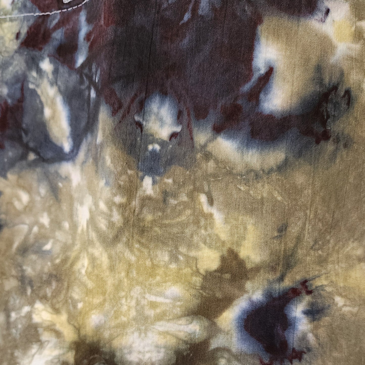 Close-up of textured fabric with beige, brown, and white colors.