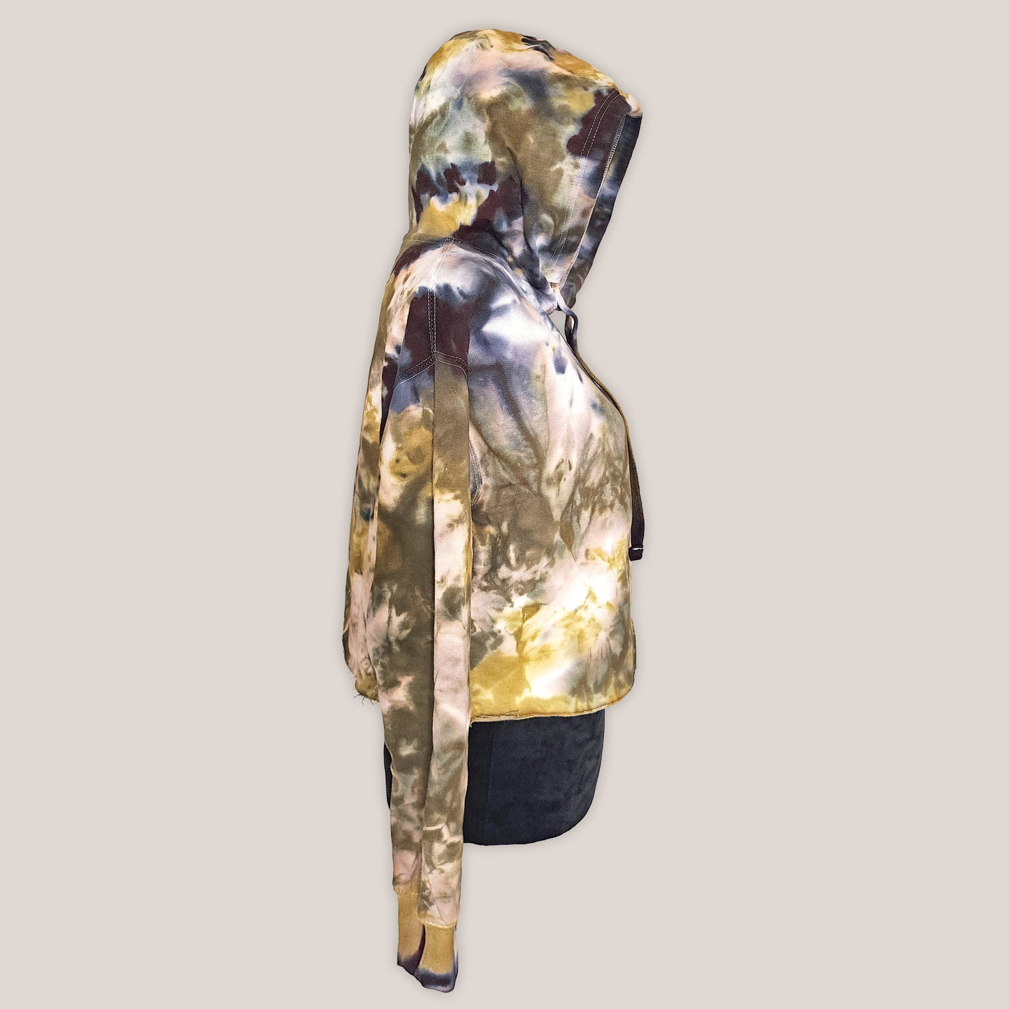 Tie Dye cropped hoodie on a black mannequin with a beige background.