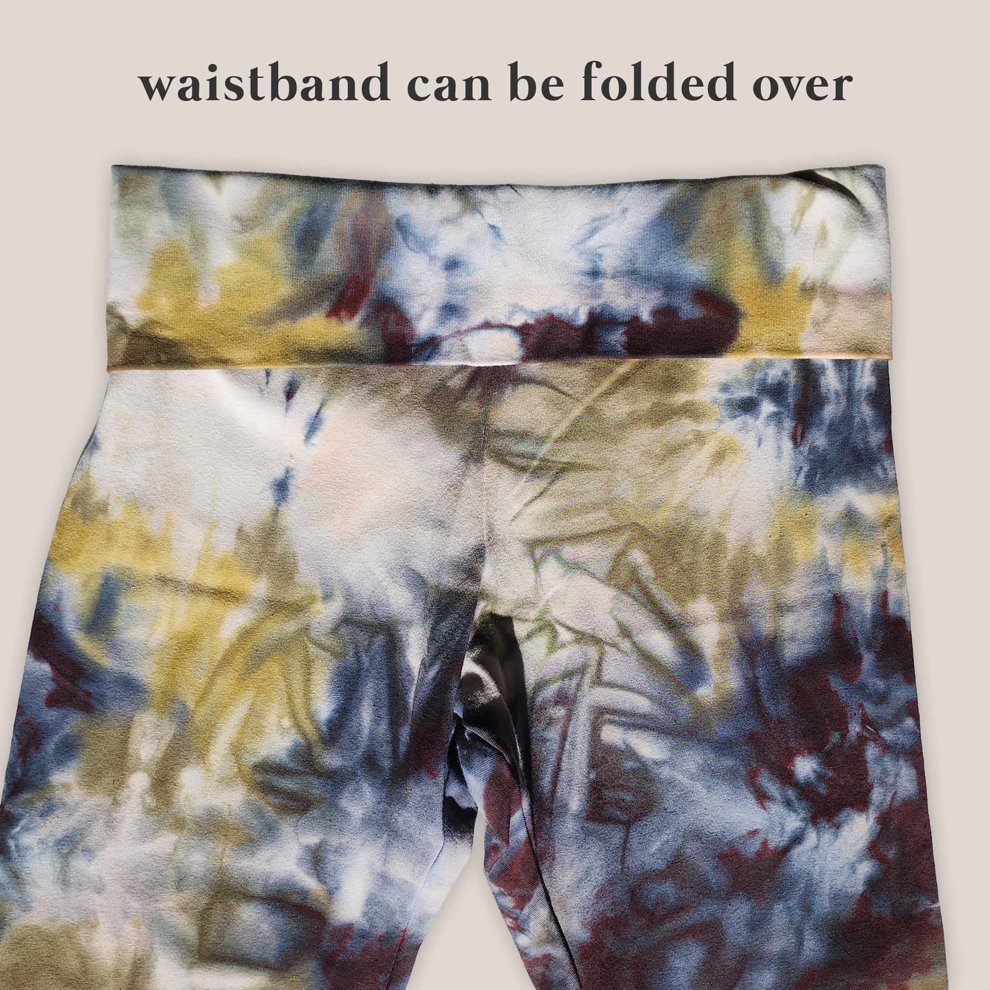 Tie-dye patterned waistband with text indicating it can be folded over.